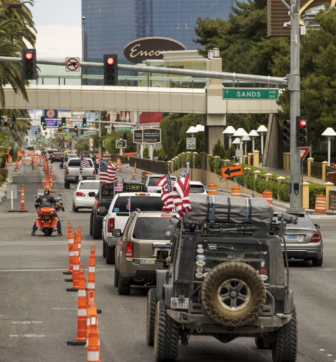 A caravan drives up the Las Vegas Strip to the Reopen Nevada protest against Gov. Sisolak to op ...