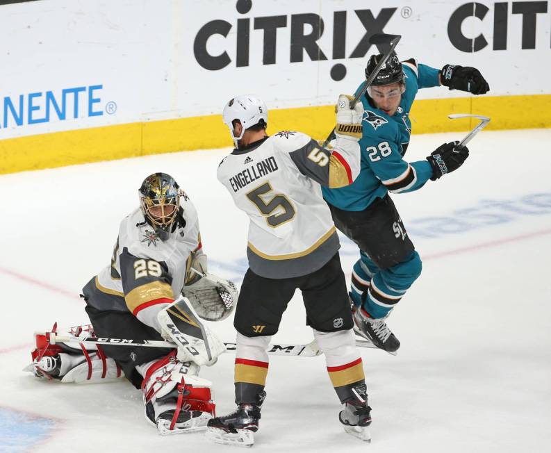 Golden Knights goaltender Marc-Andre Fleury (29) lets a puck get by him as Knights defenseman D ...
