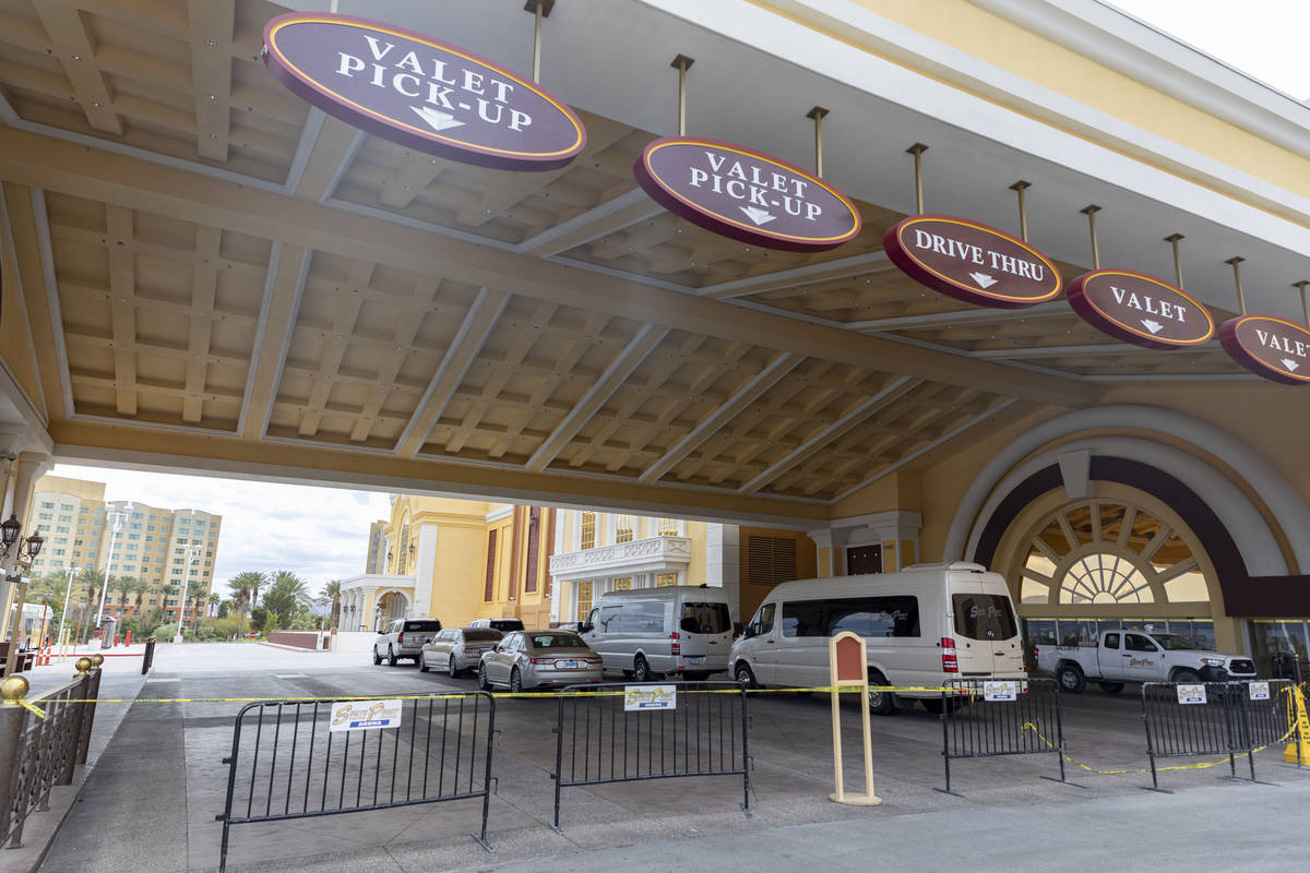 Caution tape and barriers block the valet and drive thru entrance of South Point while temporar ...