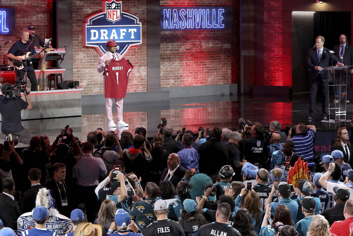 Oklahoma quarterback Kyler Murray shows off his new jersey after the Arizona Cardinals selected ...