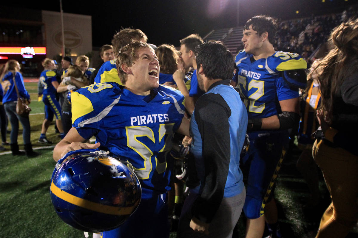 Moapa Valley players celebrate their 42-36 overtime win over Desert Pines in the Division I-A s ...