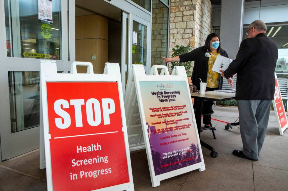 Joey Turken, center, director of Sunrise Hospital's Ethics and Compliance Department, screens a ...