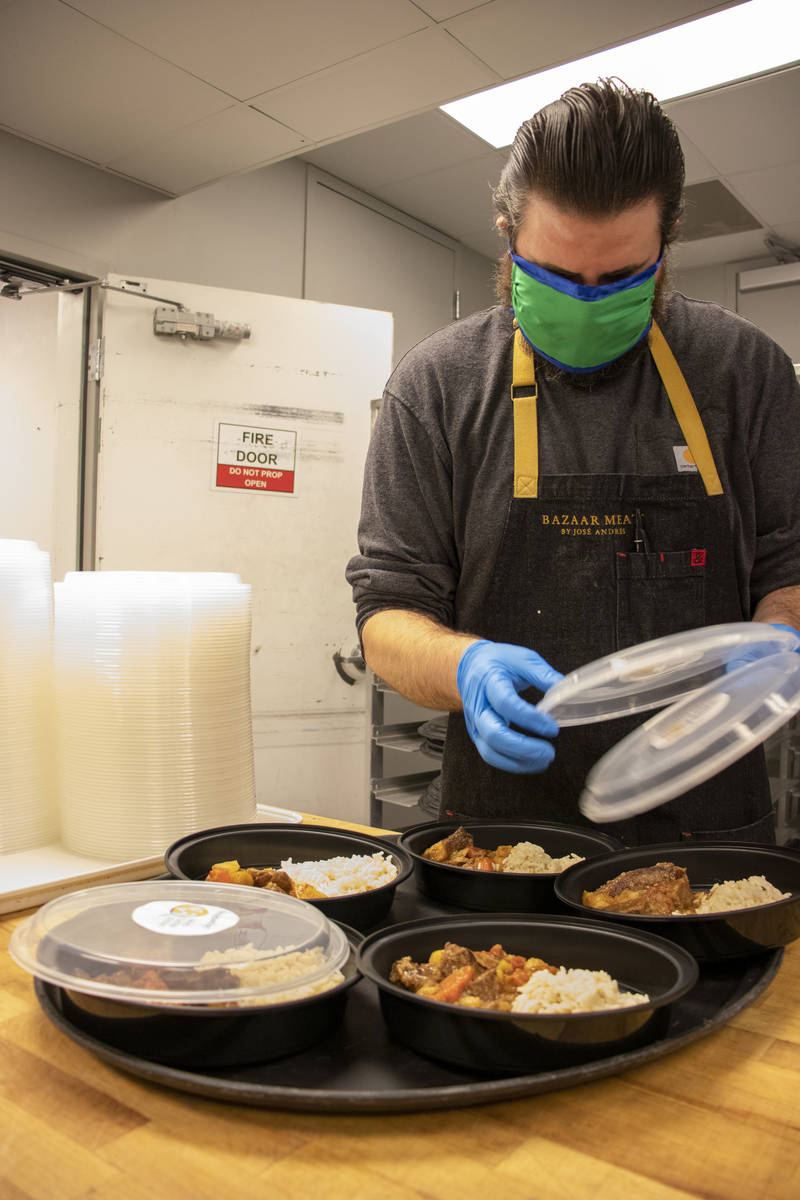 Bazaar Meat sous chef Dan Buford packs World Central Kitchen meals, intended as "a sign of hope ...