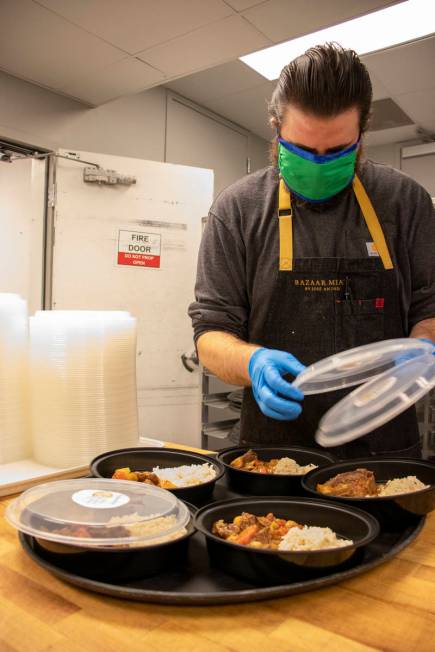 Bazaar Meat sous chef Dan Buford packs World Central Kitchen meals, intended as "a sign of hope ...