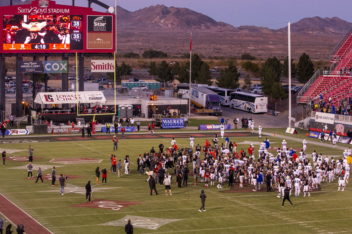 UNLV Rebels and San Jose State Spartans players and coaches come together on the field followin ...