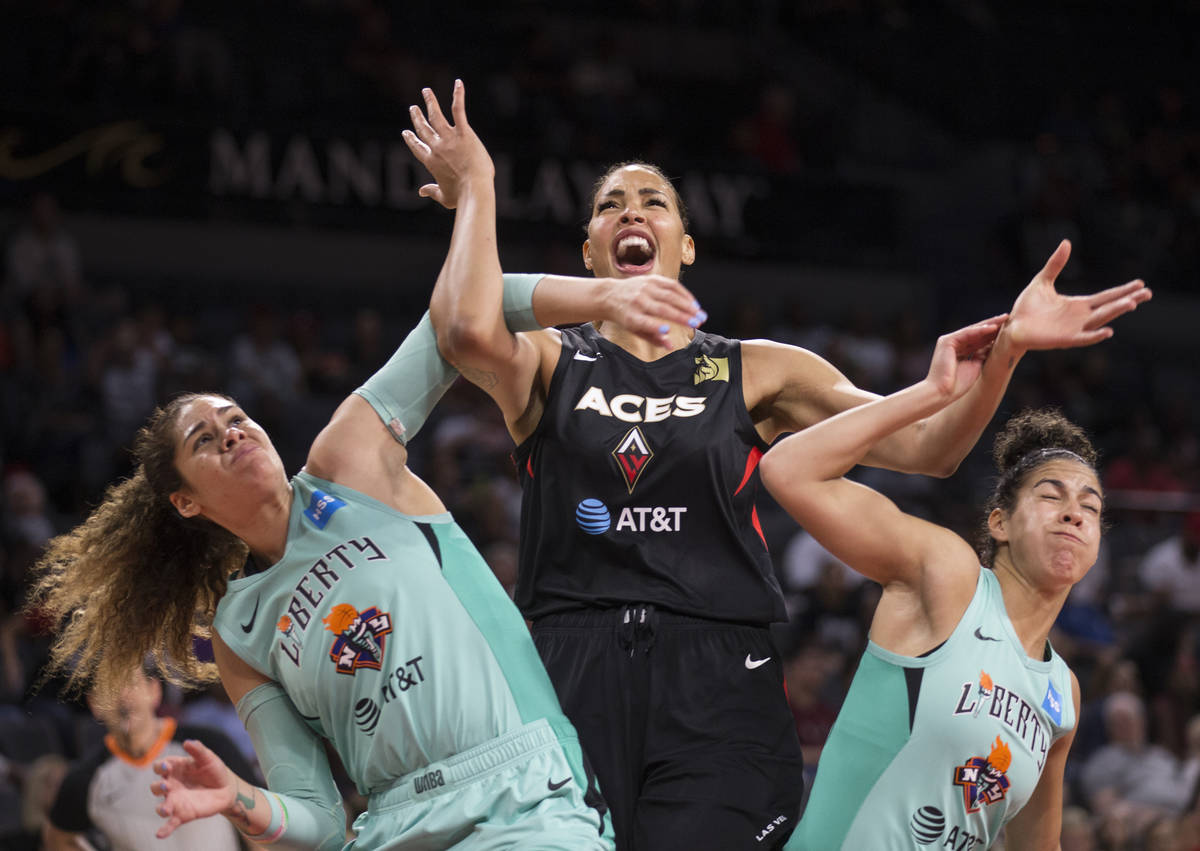 Las Vegas Aces center Liz Cambage (8) fights for position with New York Liberty center Amanda Z ...