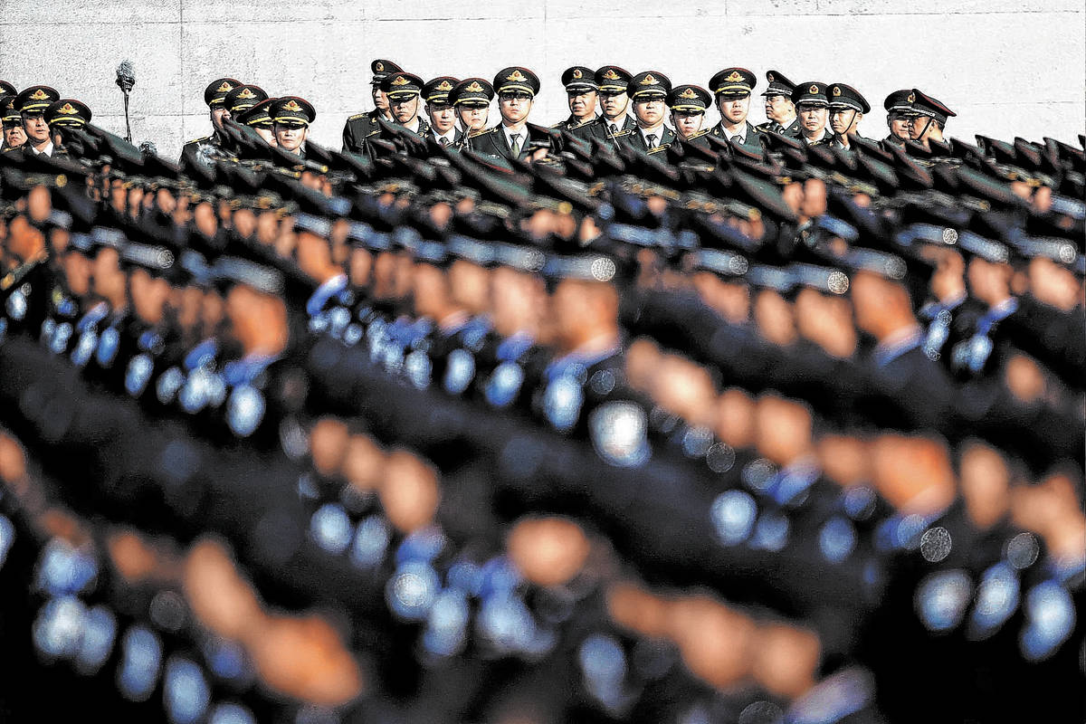 Members of the People's Liberation Army (PLA) attend a memorial ceremony at the Nanjing Massacr ...