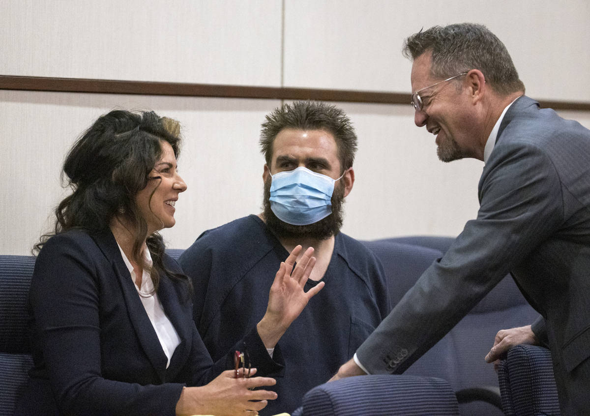 Joshua Nichols, center, confers with his lawyers Julie Raye, left, and Robert Draskovich during ...