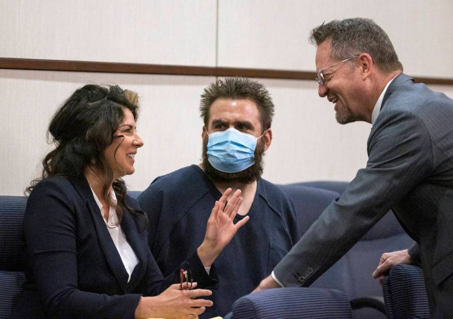 Joshua Nichols, center, confers with his lawyers Julie Raye, left, and Robert Draskovich during ...