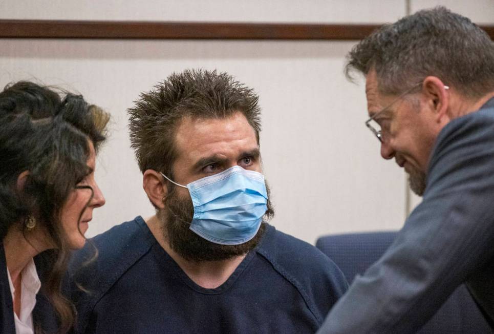 Joshua Nichols, center, confers with his lawyers Julie Raye, left, and Robert Draskovich during ...