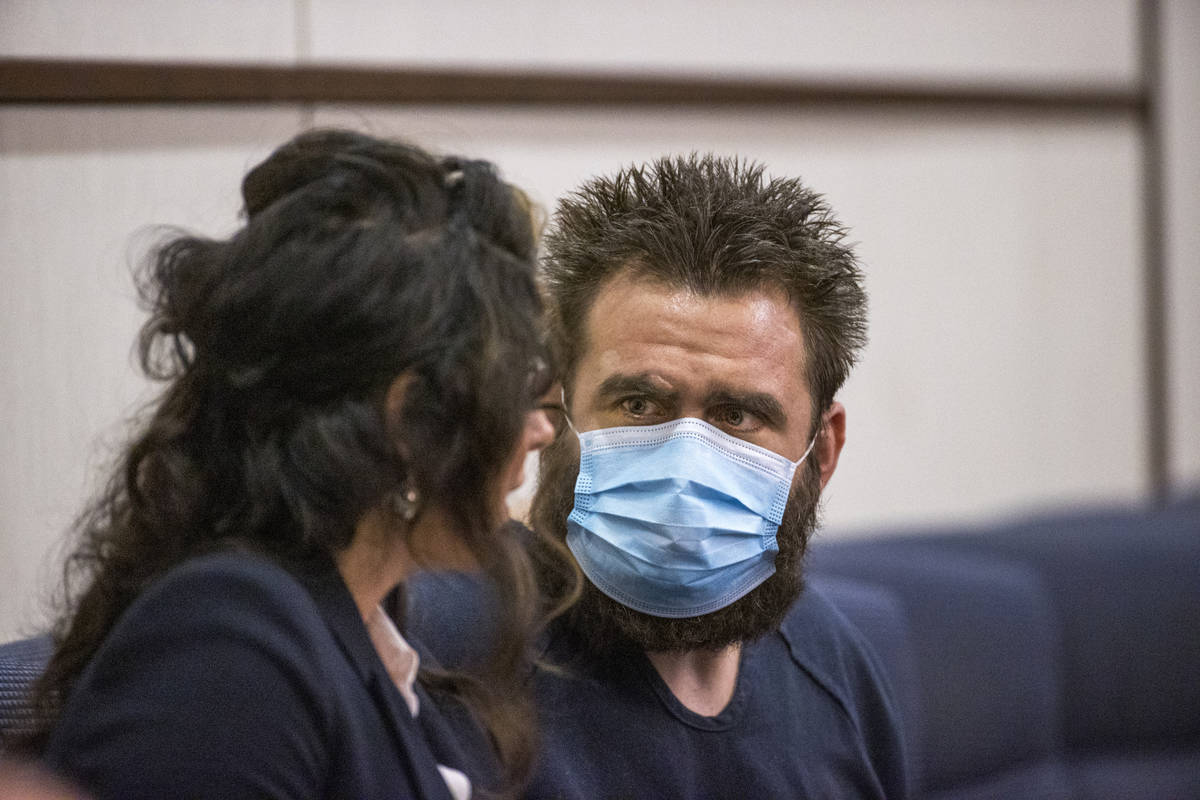 Joshua Nichols, right, confers with his lawyer Julie Raye during his hearing at Henderson Justi ...