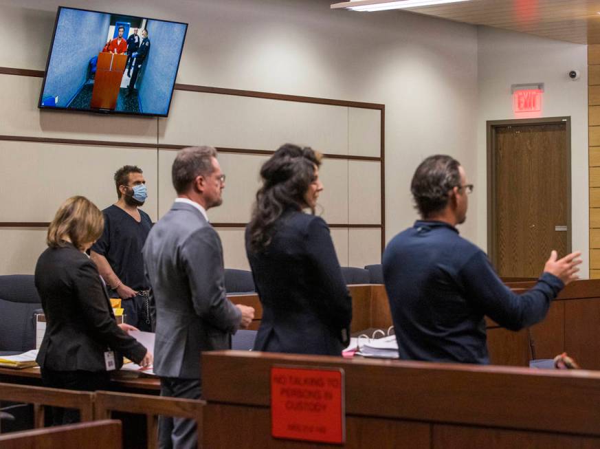 Joshua Nichols, left, listens to lawyers during a hearing with co-defendant George Moya on vide ...