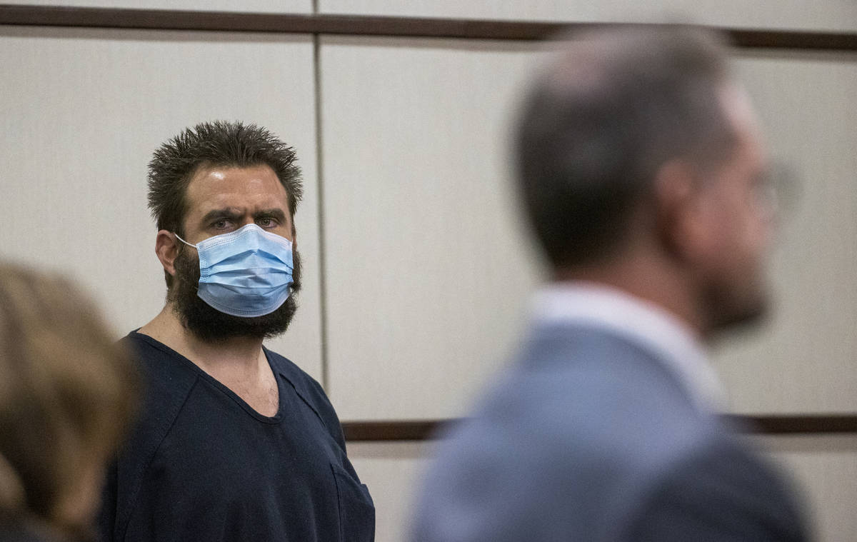 Joshua Nichols, center, listens to his lawyer Robert Draskovich, right, during his hearing at H ...