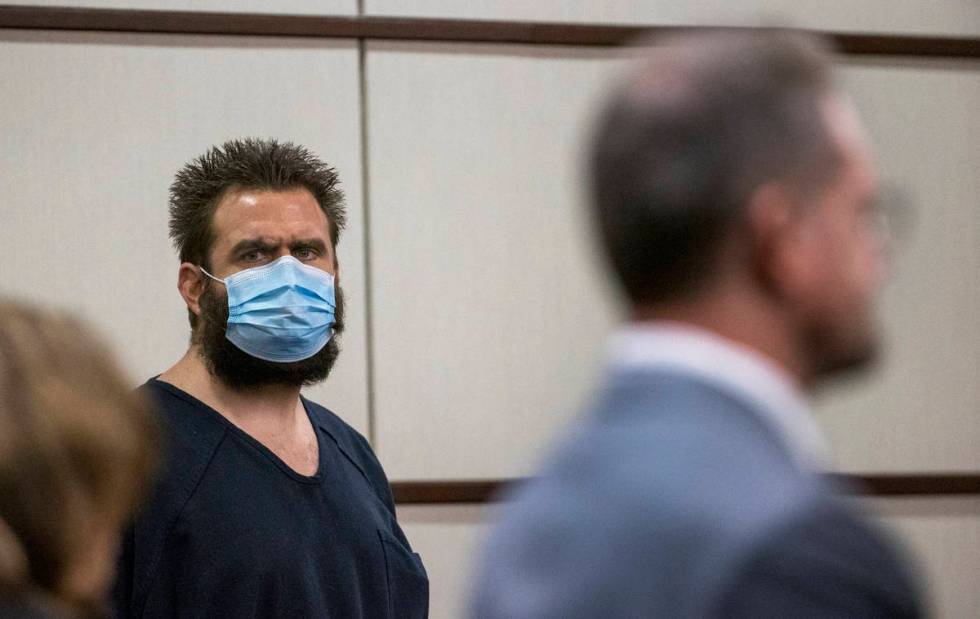 Joshua Nichols, center, listens to his lawyer Robert Draskovich, right, during his hearing at H ...