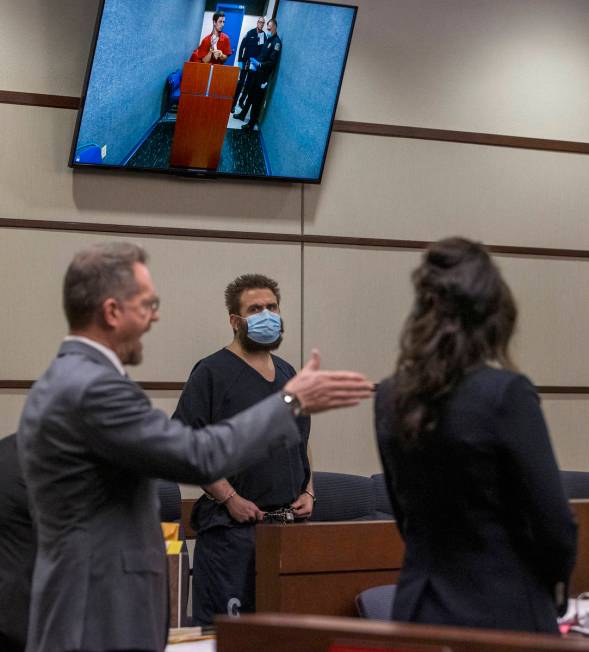 Joshua Nichols, center, listens to his lawyer Robert Draskovich during his court hearing with c ...