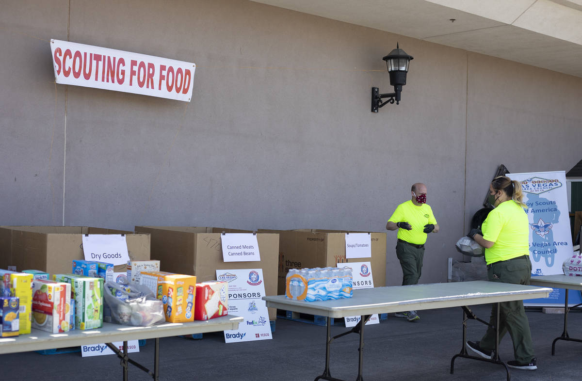 Las Vegas Council of the Boy Scouts staff members Josh Fisher, left, and Naveld Amigon, right, ...