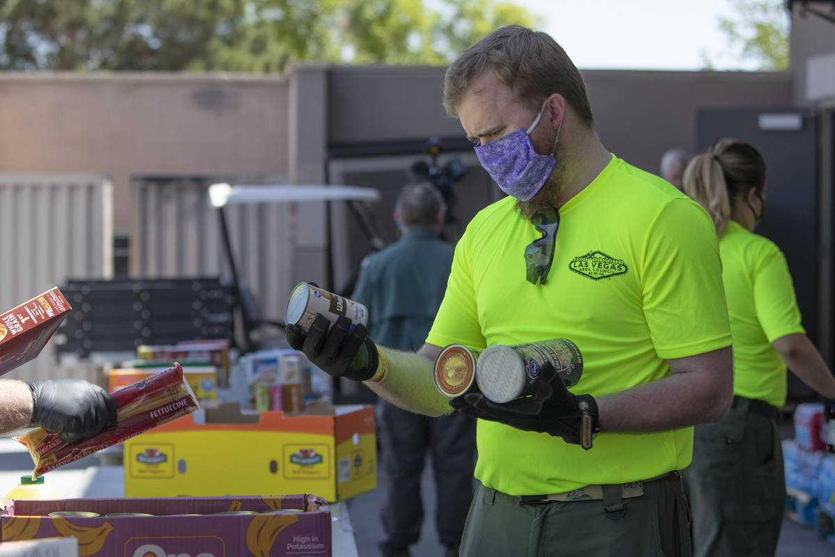 Bryce McCandless, a staff member at the Las Vegas Council of the Boy Scouts, sorts through dona ...