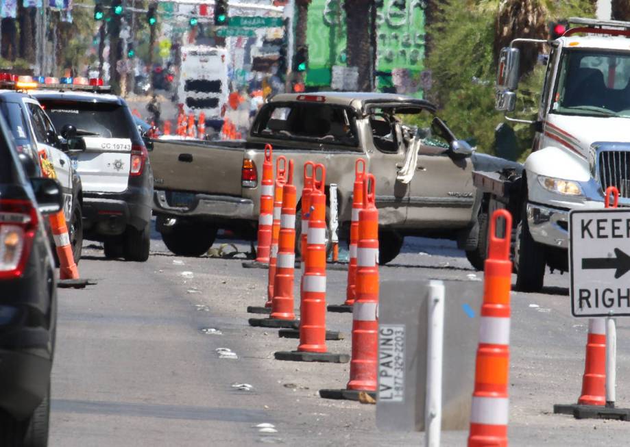 Police investigate a rollover crash on the Las Vegas Strip between Spring Mountain Road and Sah ...