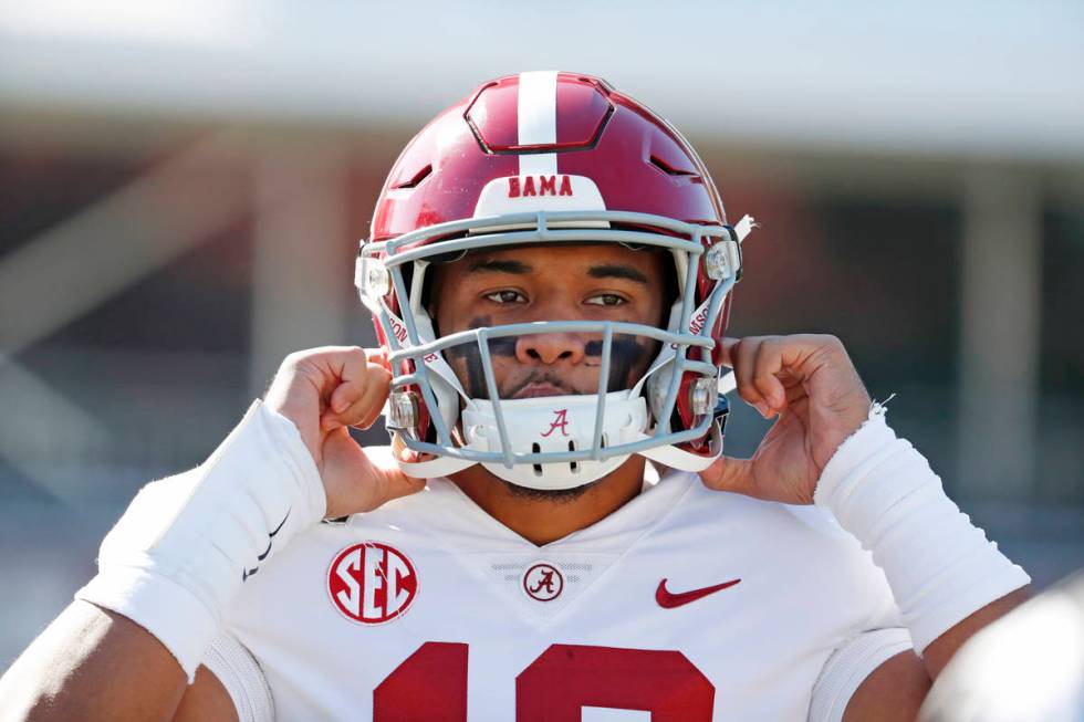 FILE - In this Nov. 16, 2019, file photo, Alabama quarterback Tua Tagovailoa (13) adjusts his h ...