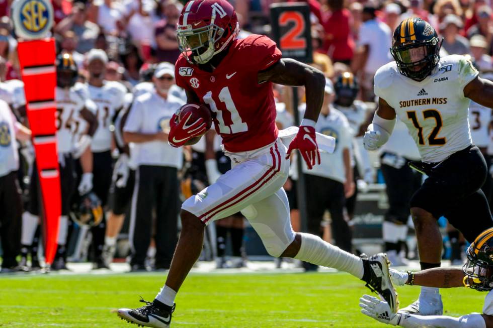 FILE - In this Sept. 21, 2019, file photo, Alabama wide receiver Henry Ruggs (11) runs in for a ...