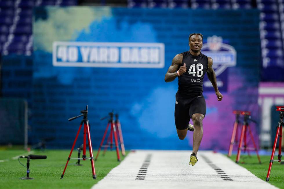 Alabama wide receiver Henry Ruggs III runs the 40-yard dash at the NFL football scouting combin ...