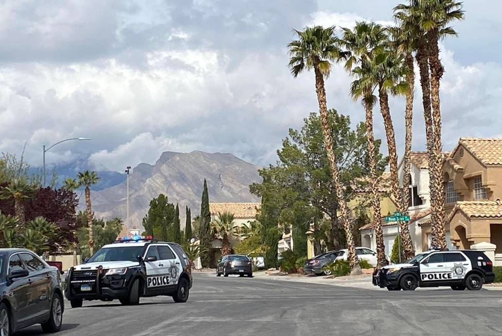 Police officers investigate a shooting in the 8400 block of Shady Shores Circle, near Rampart a ...