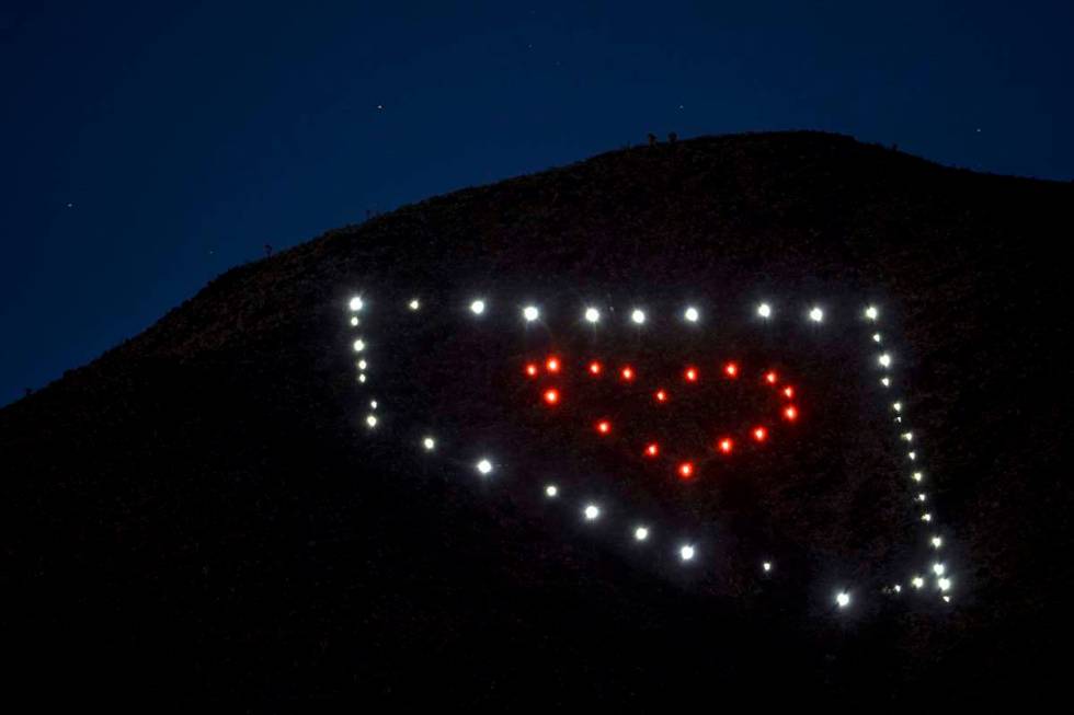 The solar lights shine brightly night falls about a Nevada light display atop of Black Mountain ...