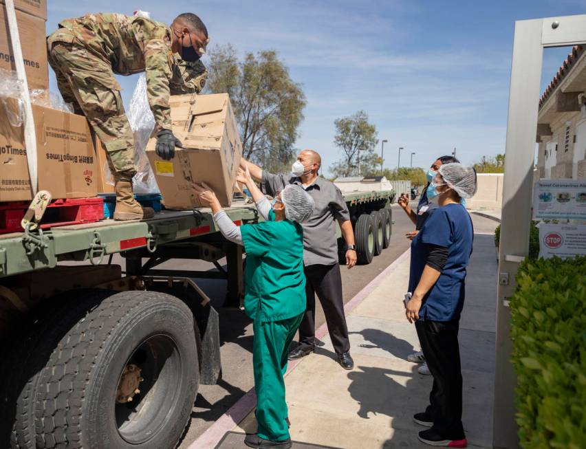The Nevada National Guard unloads boxes of personal protective equipment to Silver Hills Health ...