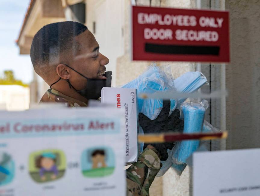 Nevada National Guard Spc. Donshay Watkins delivers surgical masks to Silver Hills Health Care ...