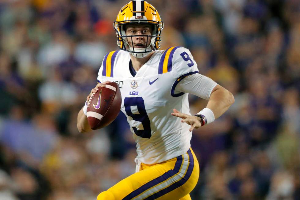 In this Nov. 30, 2019, file photo, LSU quarterback Joe Burrow (9) scrambles during the first ha ...