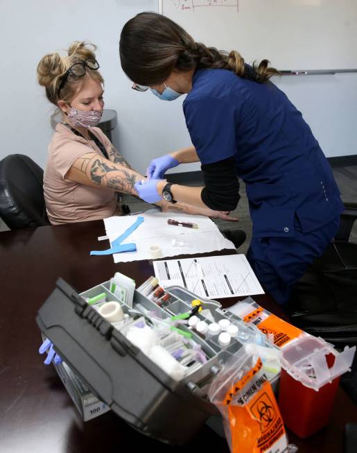 Madison Kelly, 29, lead liquid production technician at Designs for Health, receives voluntary ...