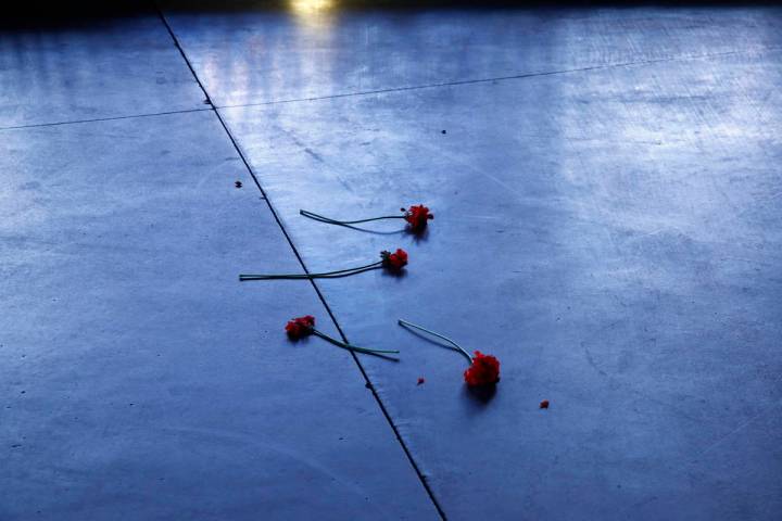 Flowers lie on a sidewalk along the Las Vegas Strip devoid of the usual crowds as casinos and o ...