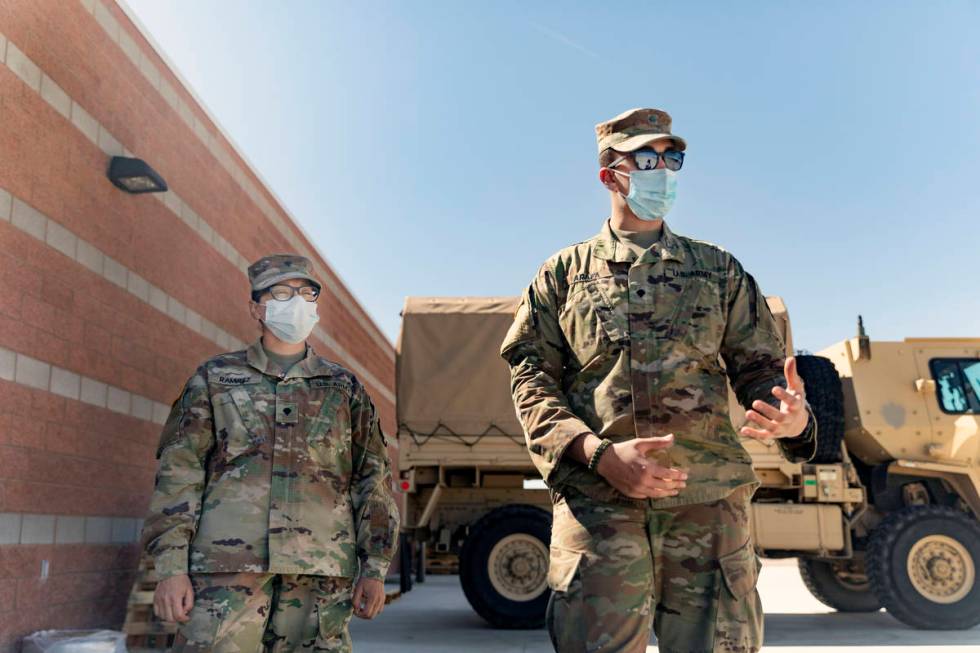 Spc. Iris Ramirez, left, and Spc. Karim Arafa discuss the mission of delivering personal protec ...