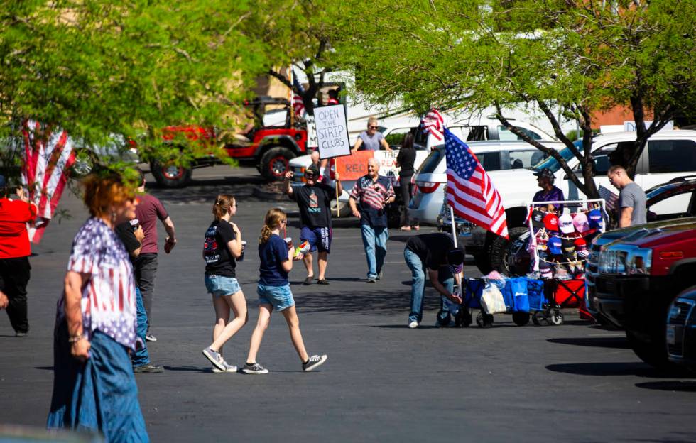 People gather at the Las Vegas South Premium Outlets before participating in a "caravan&qu ...