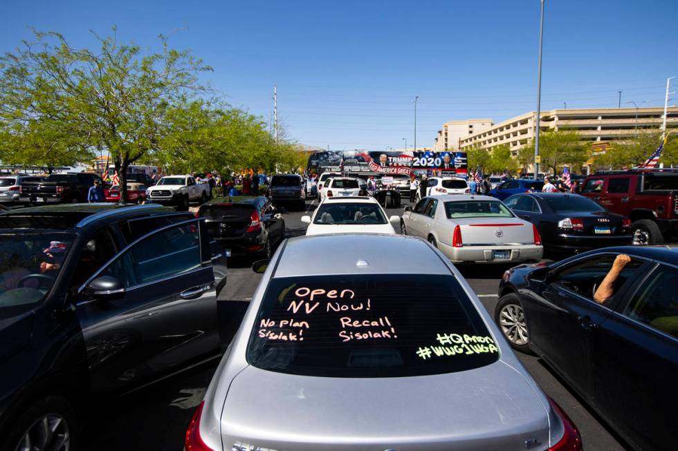 People gather at the Las Vegas South Premium Outlets before participating in a "caravan&qu ...