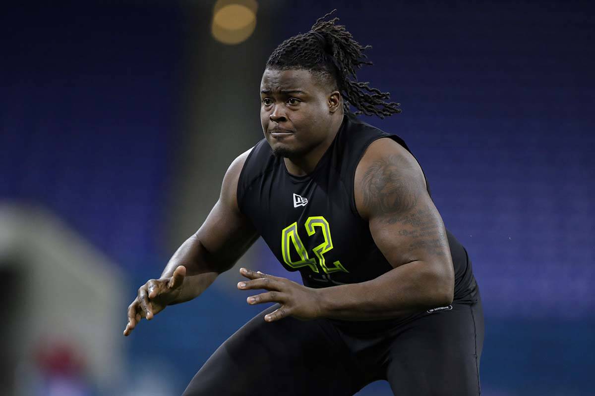 Clemson offensive lineman John Simpson runs a drill at the NFL football scouting combine in Ind ...