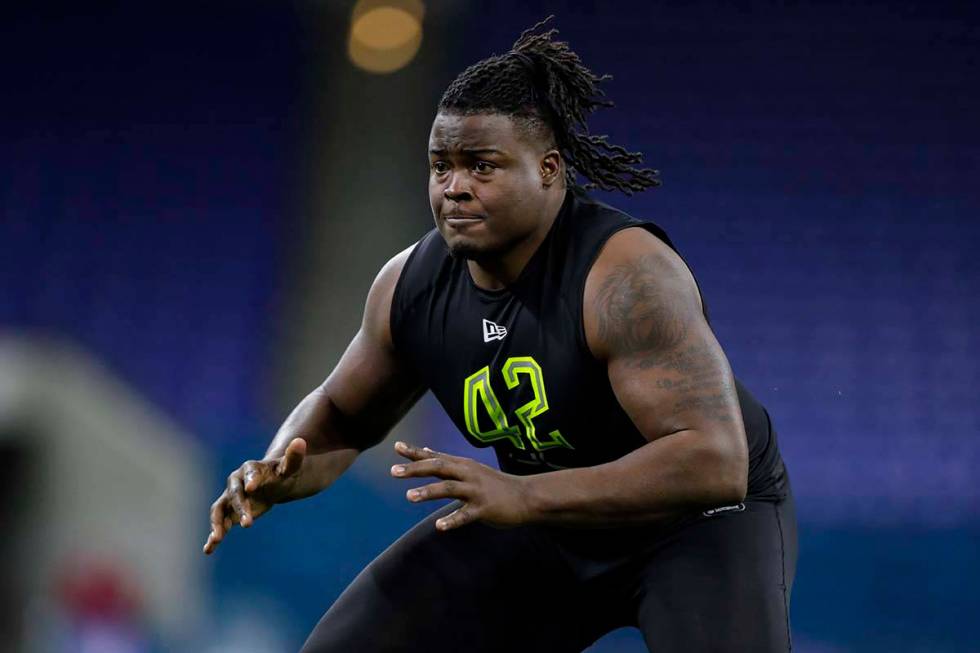 Clemson offensive lineman John Simpson runs a drill at the NFL football scouting combine in Ind ...