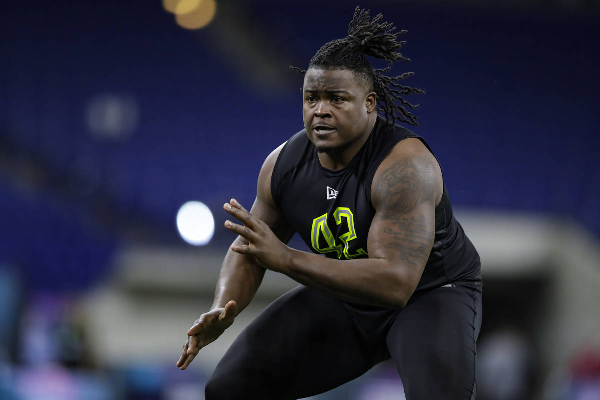 Clemson offensive lineman John Simpson runs a drill at the NFL football scouting combine in Ind ...