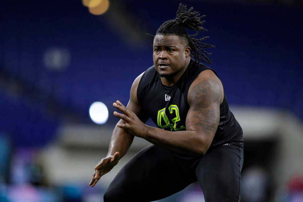 Clemson offensive lineman John Simpson runs a drill at the NFL football scouting combine in Ind ...