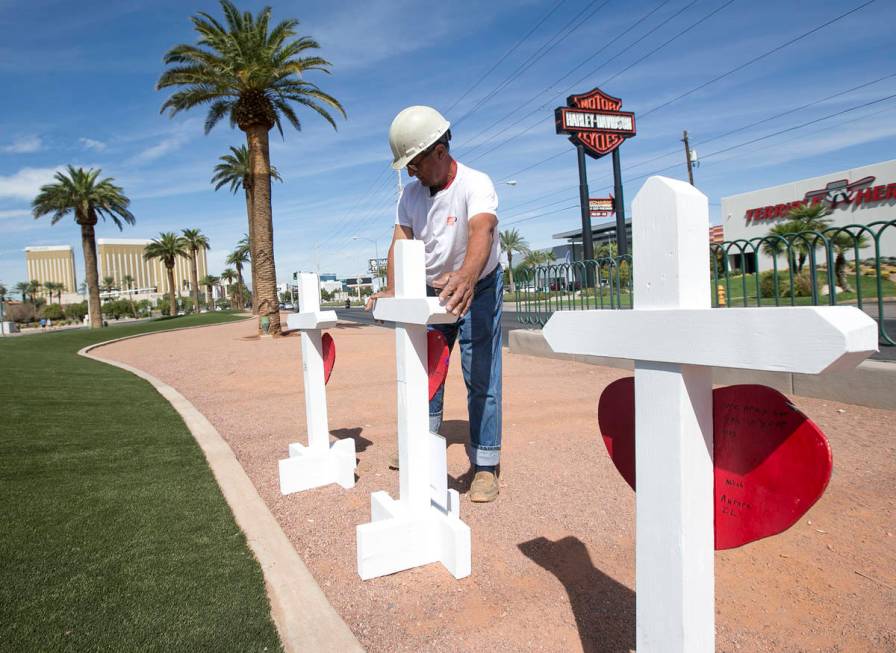 Greg Zanis, of Aurora, Ill., positions 58 crosses near the Welcome to Fabulous Las Vegas sign h ...