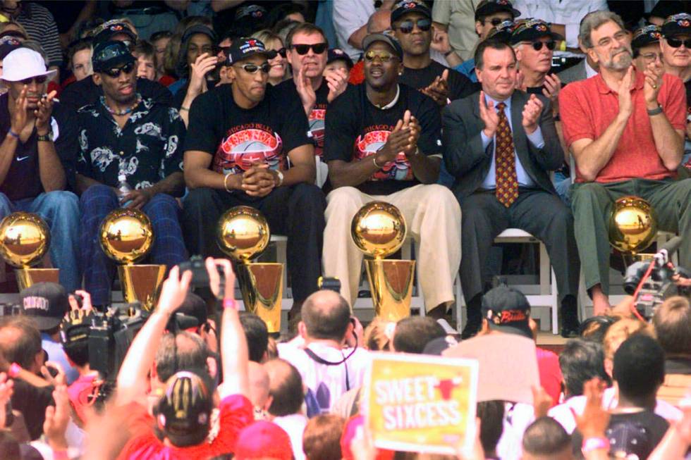 FILE - In this June 16, 1998, file photo, NBA Champions, from left: Ron Harper, Dennis Rodman, ...