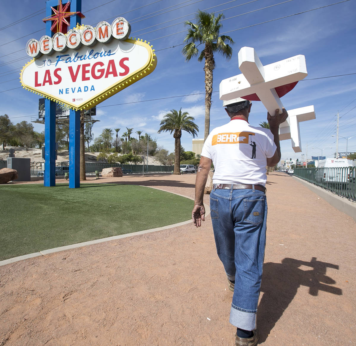 Greg Zanis, of Aurora, Ill., carries one of 58 crosses he placed near the Welcome to Fabulous L ...