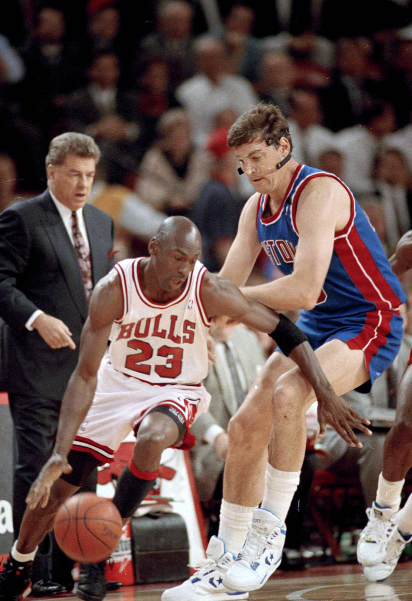 The Chicago Bulls' Michael Jordan (23) moves around the Detroit Pistons' Bill Laimbeer (40) dur ...