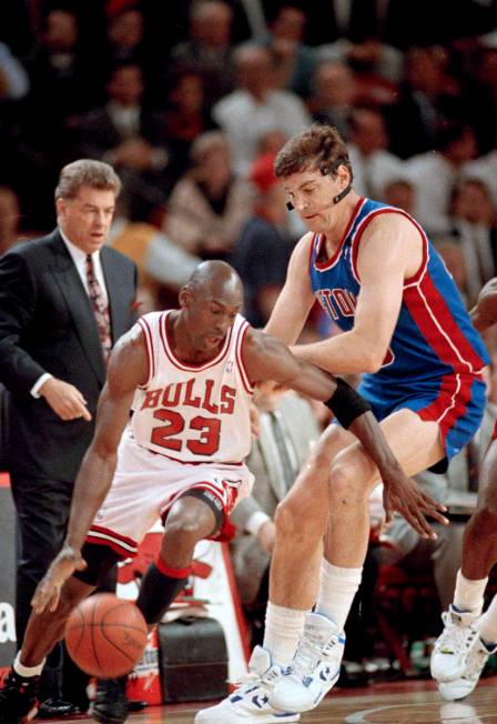 The Chicago Bulls' Michael Jordan (23) moves around the Detroit Pistons' Bill Laimbeer (40) dur ...