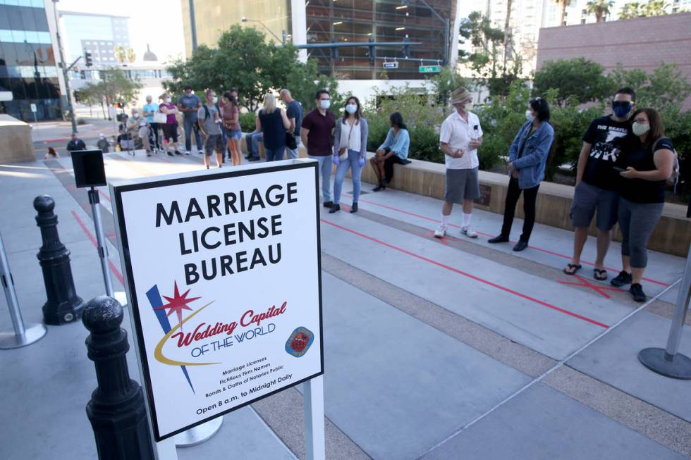 Couples, including first-in-line Jenny Paez and George Wells of Las Vegas, right, wait for for ...