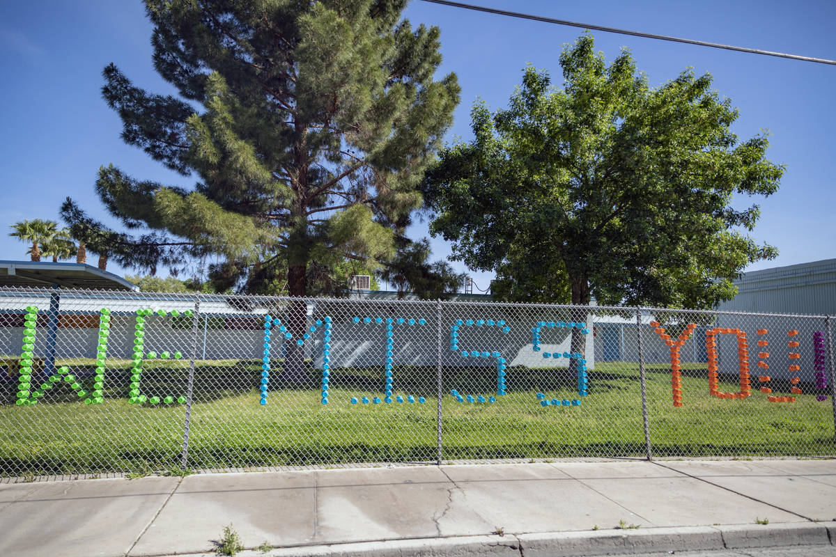 A sign made out of plastic cups is seen as individuals arrive to collect food at Matt Kelly Ele ...