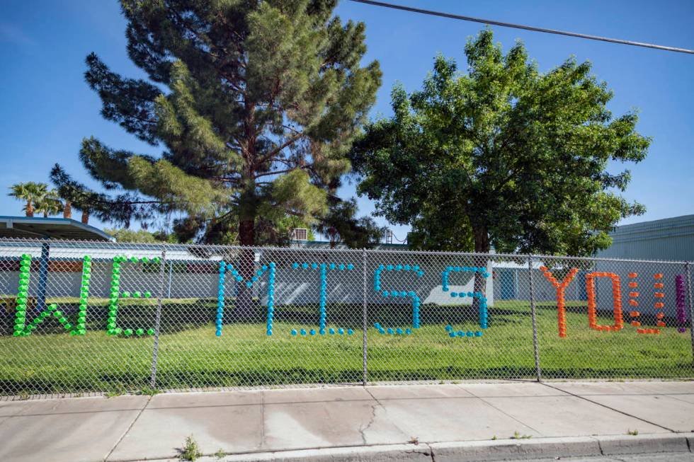 A sign made out of plastic cups is seen as individuals arrive to collect food at Matt Kelly Ele ...