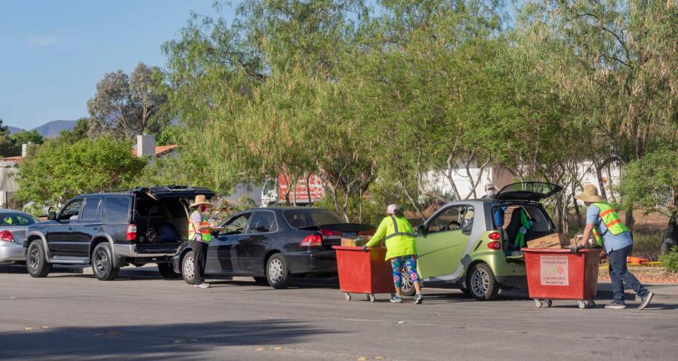 A line of cars stretching one mile down Palo Verde Drive, collect meals from St. Therese Center ...