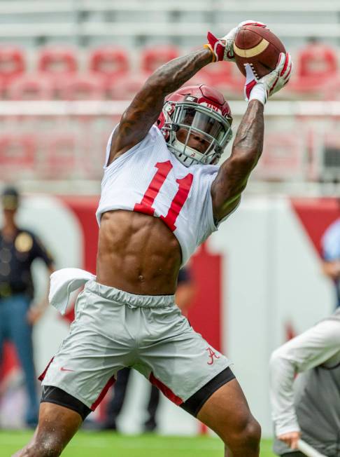 Alabama wide receiver Henry Ruggs III (11) works through drills in Alabama's fall camp fan-day ...