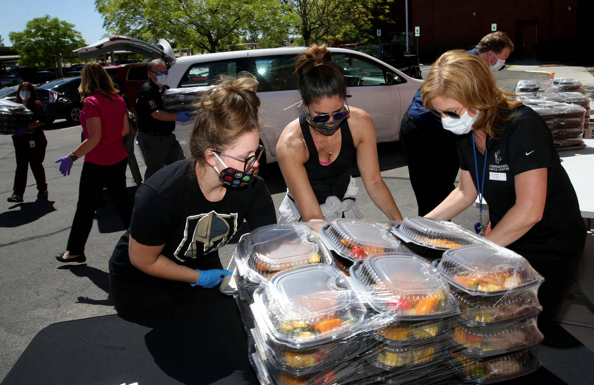 Vegas Golden Knights Foundation Manager Mia Festenese, left, and President Kim Frank, center, d ...